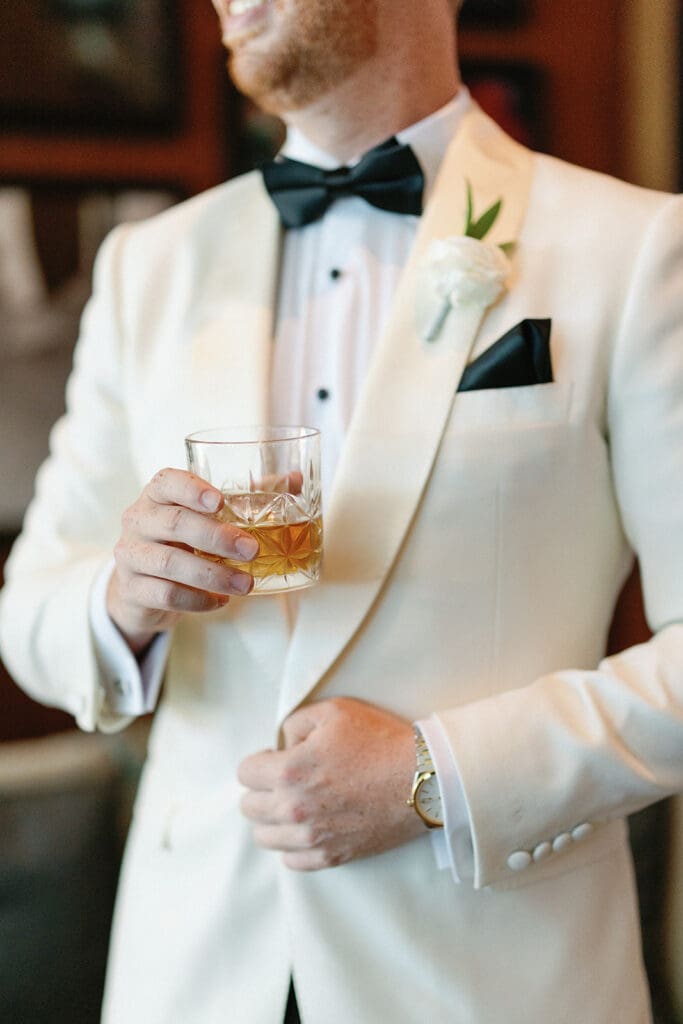 groom holding whiskey